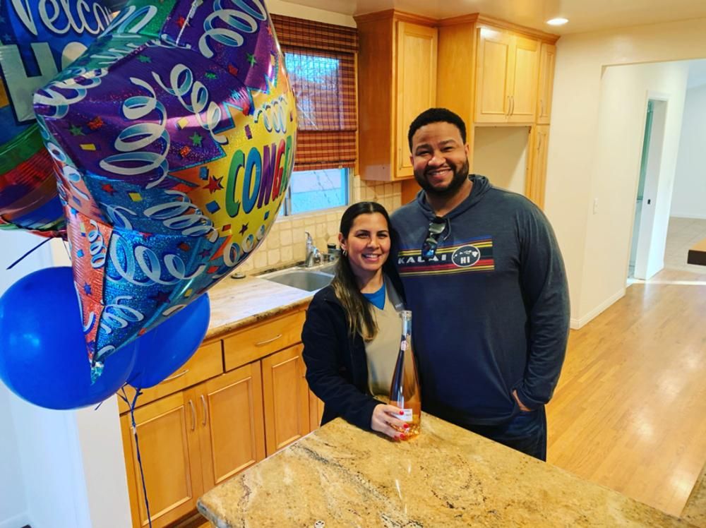 Happy buyers in the kitchen of their new home
